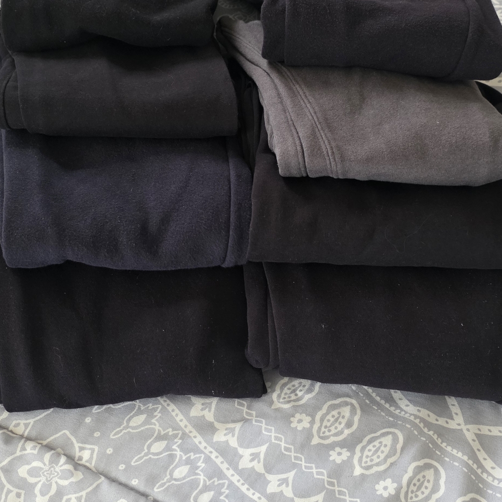 Stack of Black and Dark Gray Sweatshirts